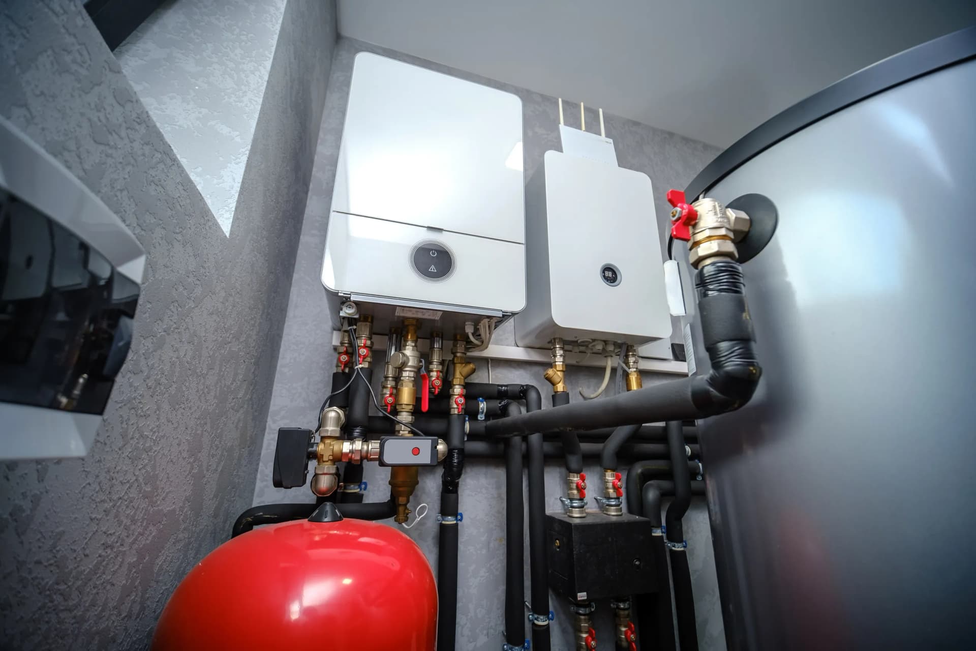 Clean condensing boiler installation with manifold and copper piping basement mechanical room